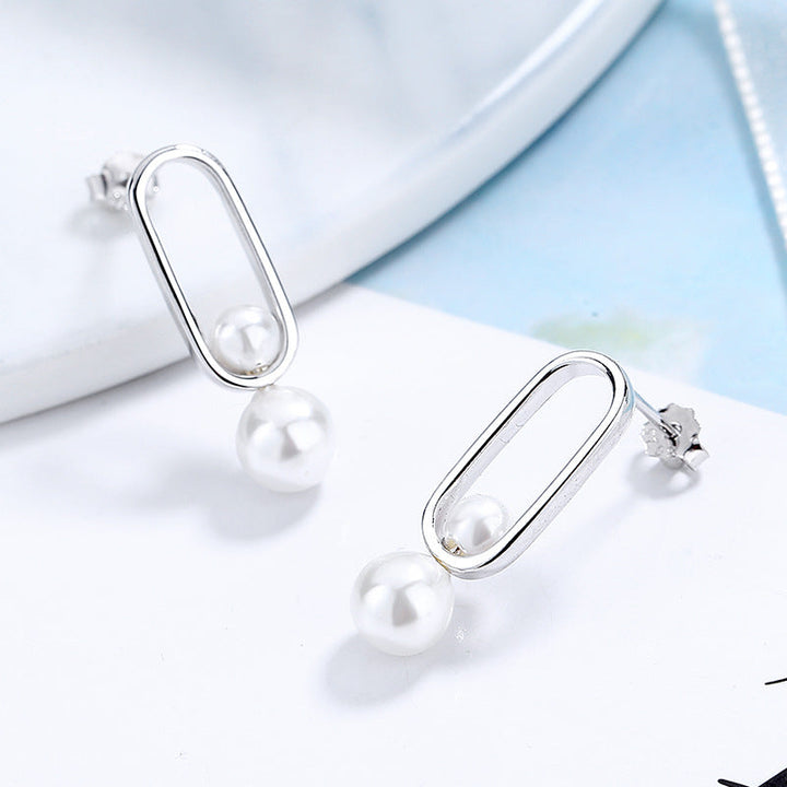 Women's stud earrings with modern oval design and elegant pearls All Fashion