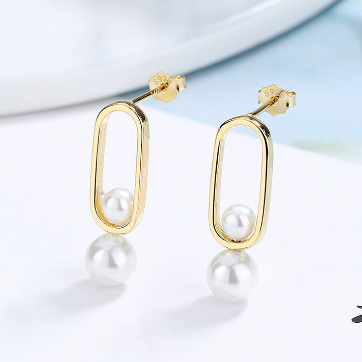 Women's stud earrings with modern oval design and elegant pearls All Fashion